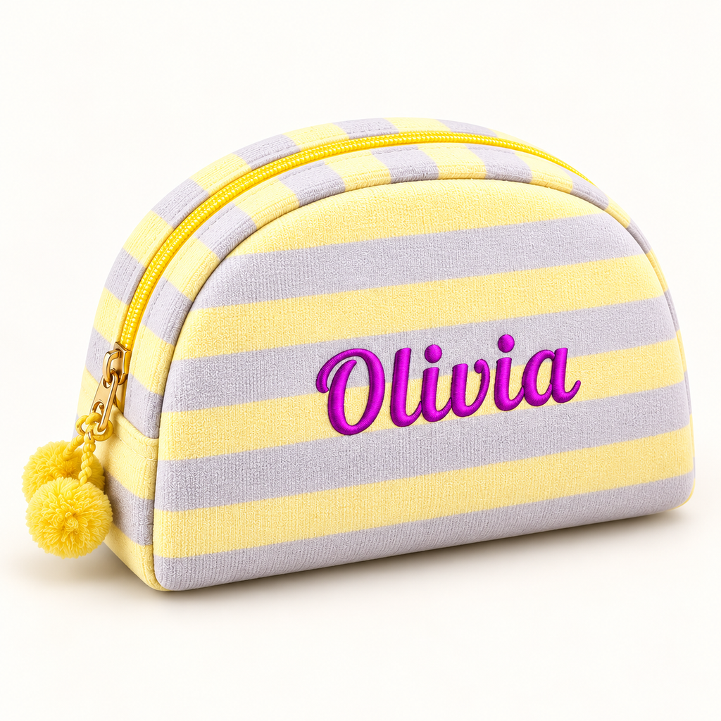 Lemon and lilac striped makeup pouch with purple Olivia embroidery and yellow pom-poms.