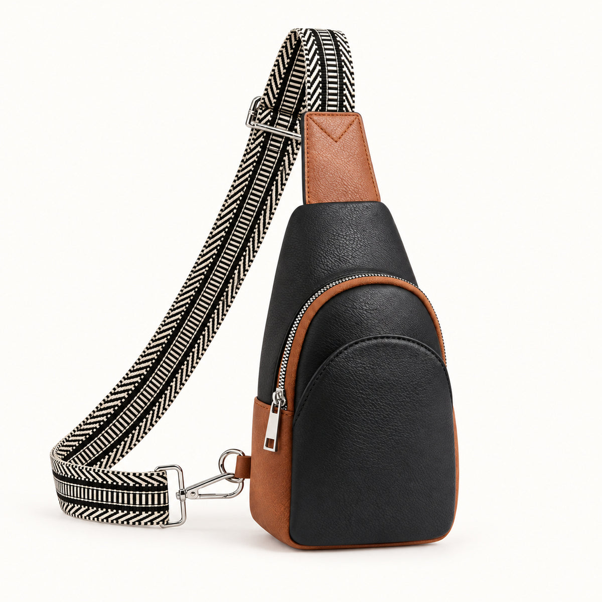 Black and Cognac teardrop sling bag with black and ivory geometric woven strap and silver-tone hardware.