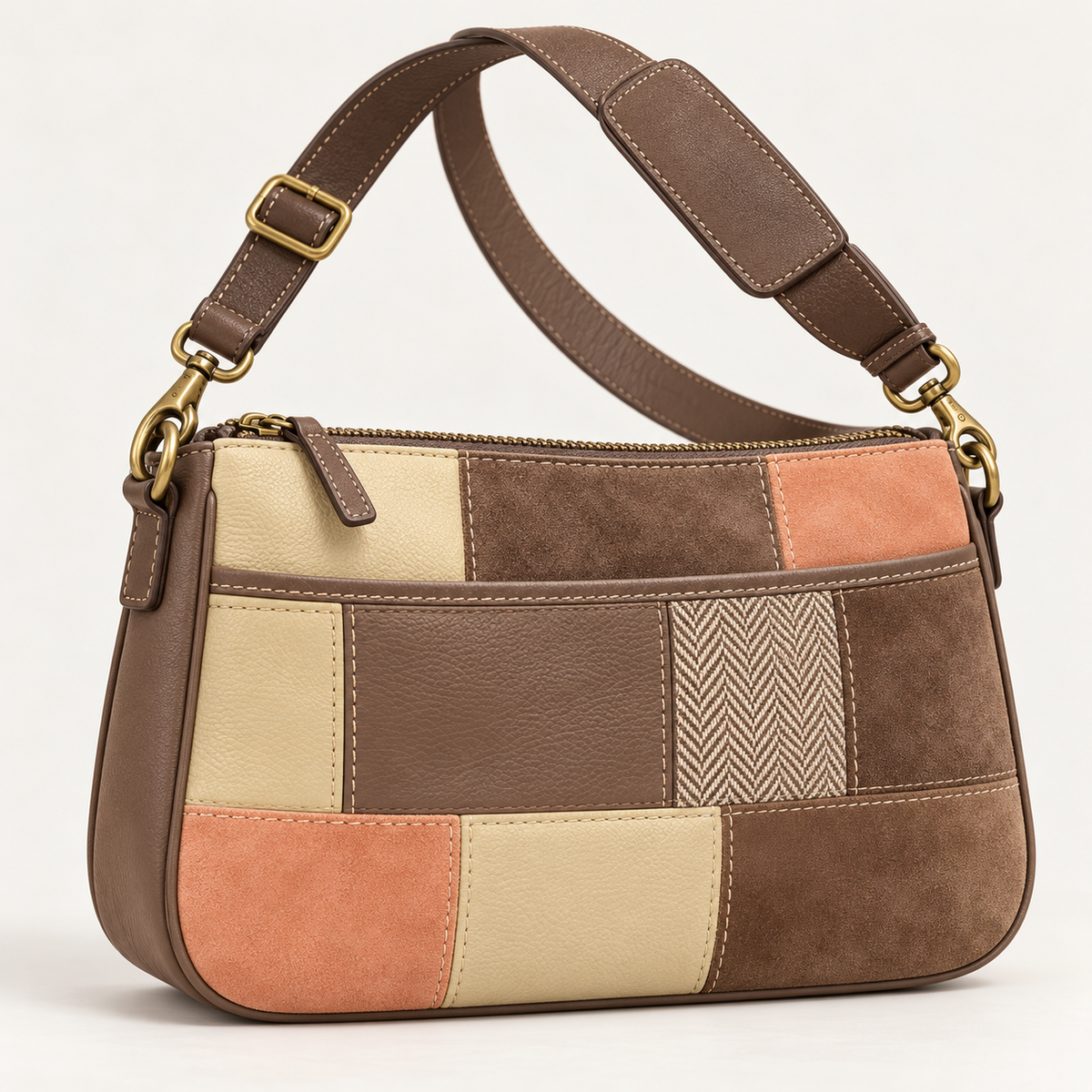 Taupe, apricot and cream patchwork crossbody bag with contrast stitching and antique brass-tone hardware.