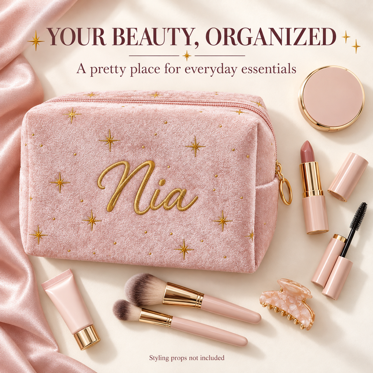 Blush pink Starlit Velvet Personalized Makeup Bag with gold stars and example name Nia, styled with everyday beauty essentials. Styling props are not included.